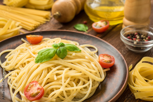 Tasty hot spaghetti with tomatoes and basil