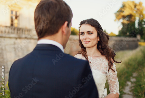 .attractive bride looking at the groom © myronovychoksana