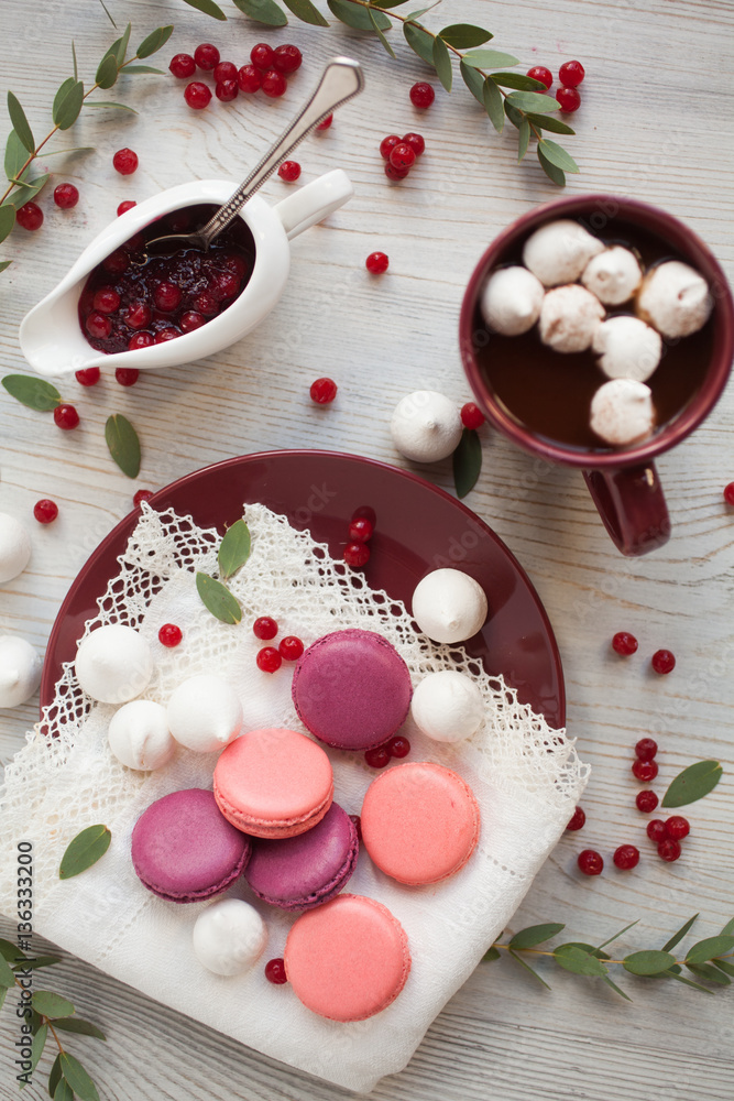 Serving table: cacao with marshmallow, berry jam and macaroons. Serving table: cacao with marshmallow, berry jam and macaroons.