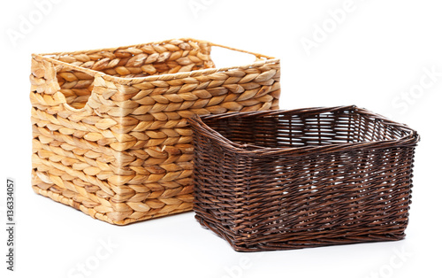 Empty brown wicker woven basket isolated on white background