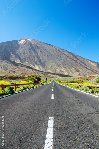 Country asphalt road background with focus on foreground and blu