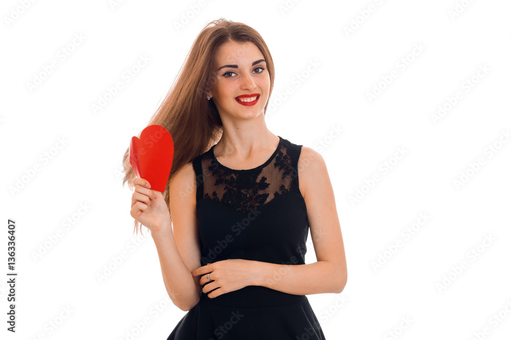 Cheerful young brunette woman with red heart in hands posing isolated on white background. Saint Valentine's day concept. Love concept. Cheerful young brunette woman with red heart in hands posing isolated on white background. Saint Valentine's day concept. Love concept.