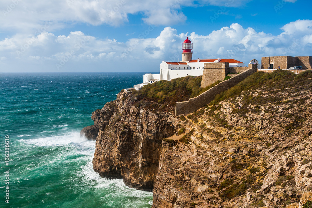Lighthouse and cliffs at Cape Saint Vicent in Algarve region on a windy day. Portugal.