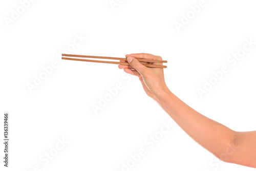 Woman hand holding chopsticks, isolated on white