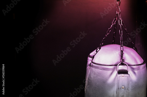 Dark background for boxers.  Punching bag for workout. © ccestep8