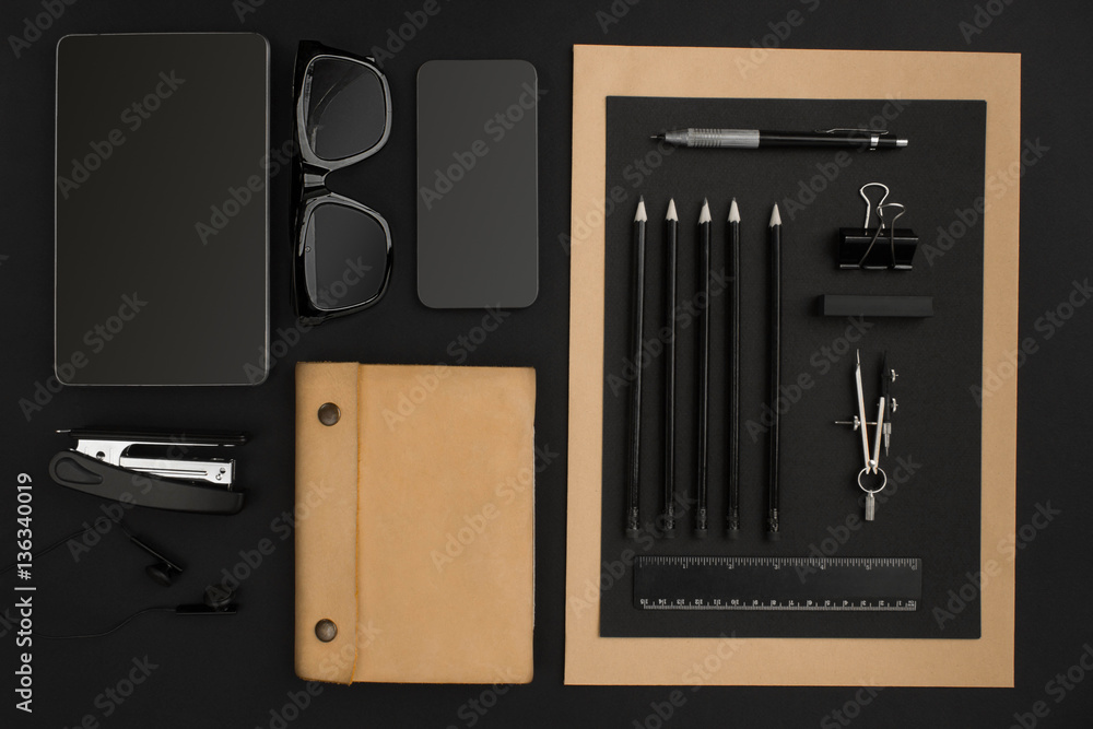 Naklejka premium Office desktop with various black objects on background