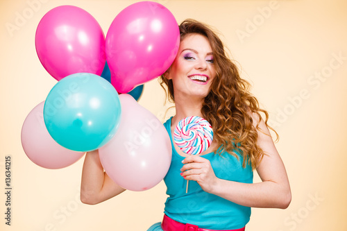 Woman with colorful balloons and lollipop