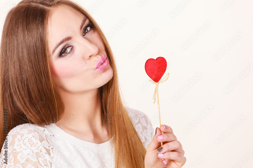 Beautiful woman holding heart shaped hand stick Beautiful woman holding heart shaped hand stick