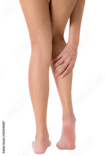 woman hand holding her leg with massaging calf in pain area, Isolated on white background. © kintarapong