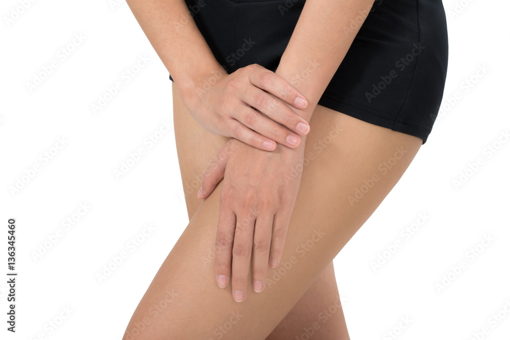 Woman massage her thigh in pain area isolated on white background Woman massage her thigh in pain area isolated on white background