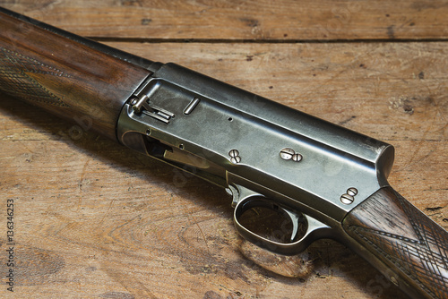 hunting rifle on rustic wooden background