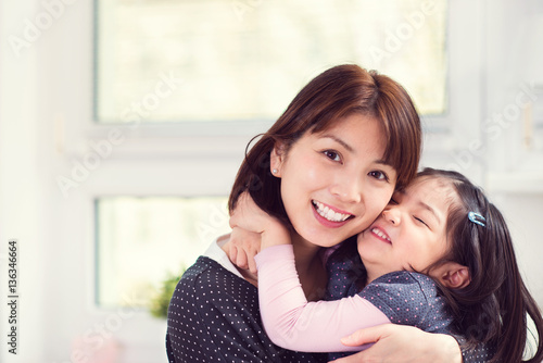 Portrait of happy mother hugging with her cute little daughter a © spass
