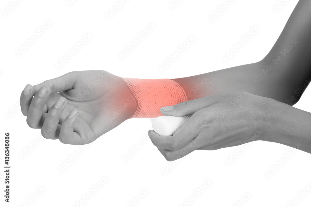 woman bandaging first aid her wrist in pain area black and white color with red highlighted isolated on white background woman bandaging first aid her wrist in pain area black and white color with red highlighted isolated on white background