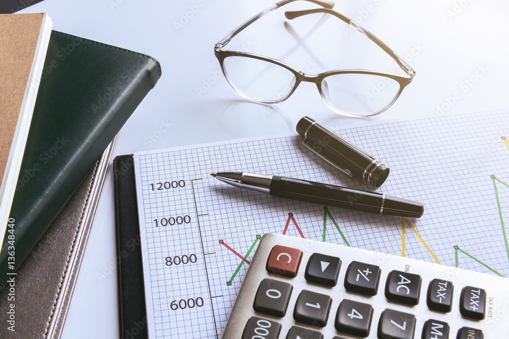 Eyeglasses and pen on financial document with data Eyeglasses and pen on financial document with data
