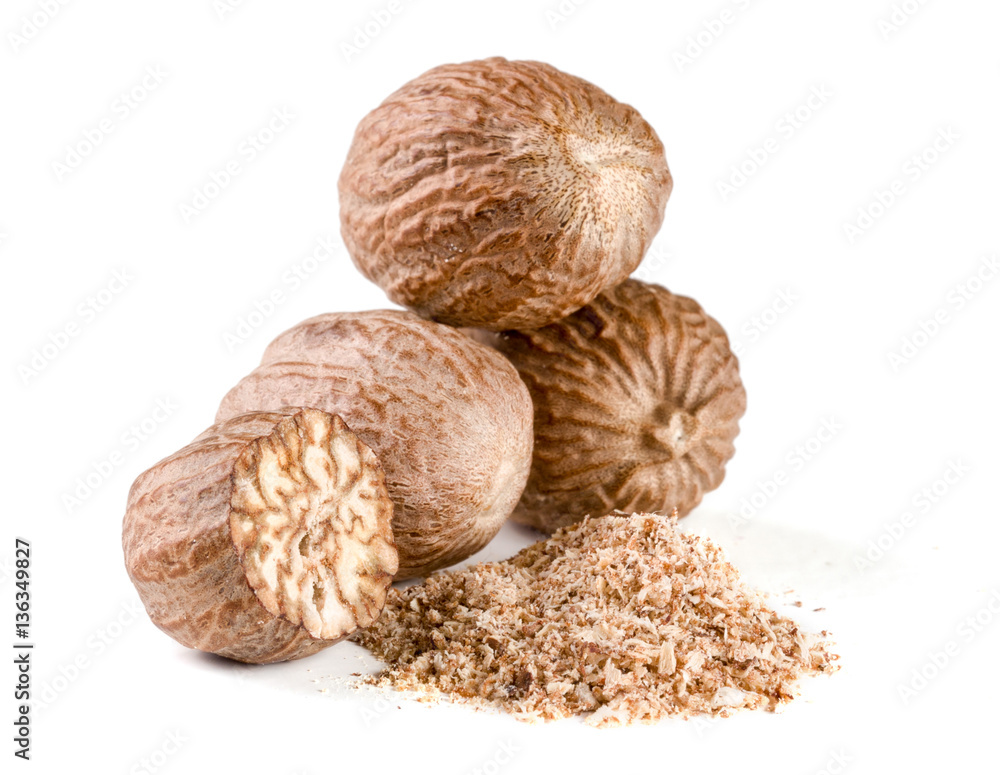 Three nutmeg and powder isolated on white background Three nutmeg and powder isolated on white background