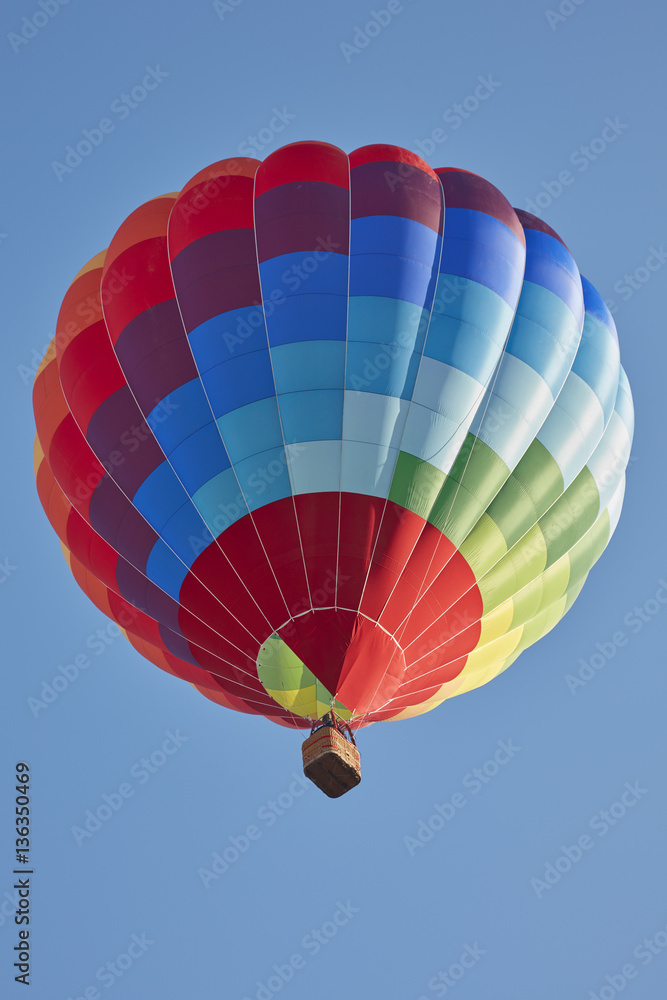 Fototapeta premium Hot air balloon, colorful aerostat on clear blue sky in a sunny day