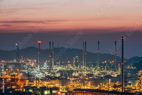 Aerial view oil refinery night with mountain background during twilight,Industrial zone,Energy power station.