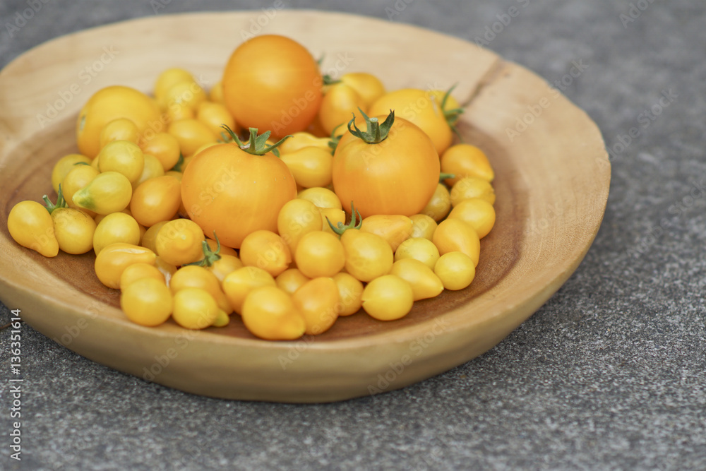 Wood Plate of Fresh Homegrown Ripe Yellow Tomatoes Wood Plate of Fresh Homegrown Ripe Yellow Tomatoes