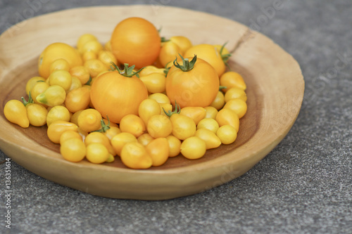 Wood Plate of Fresh Homegrown Ripe Yellow Tomatoes