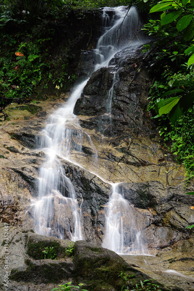 Obraz premium A beautiful waterfall inside tropical rainforest. Long exposure and slow shutter