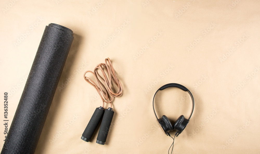 Black yoga mat, headphones and jumping rope Black yoga mat, headphones and jumping rope
