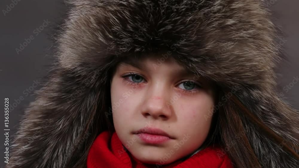 Beautiful little girl in a fur hat posing in studio. Video resolution of 4K Beautiful little girl in a fur hat posing in studio. Video resolution of 4K