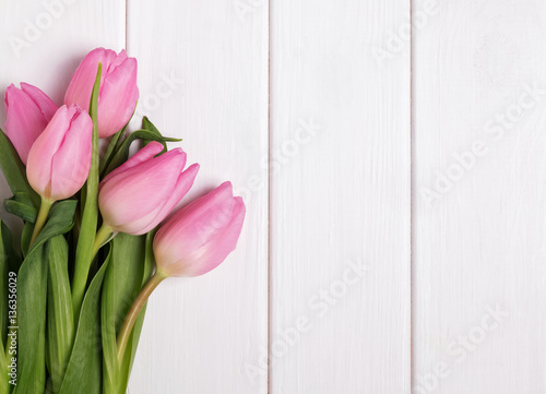 Pink tulips on wooden table