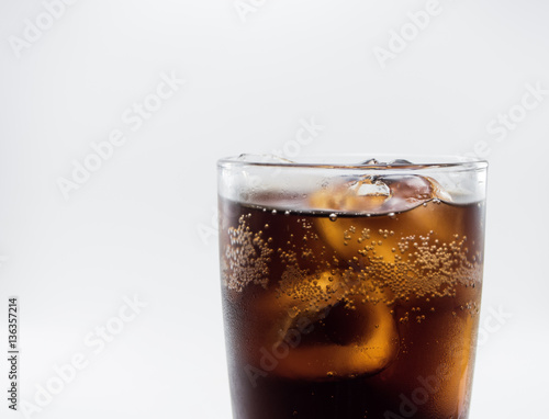 close up full soft drink is cool and ice cubes  in glass on white background