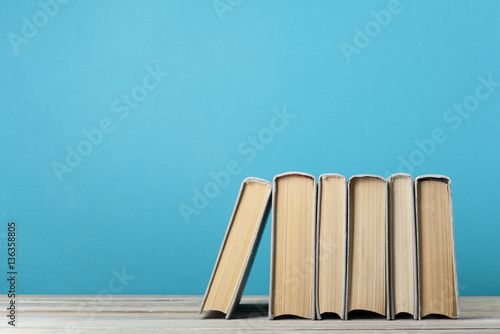 Stack of books on the wooden table. Education background.Back to school.Copy space for text.