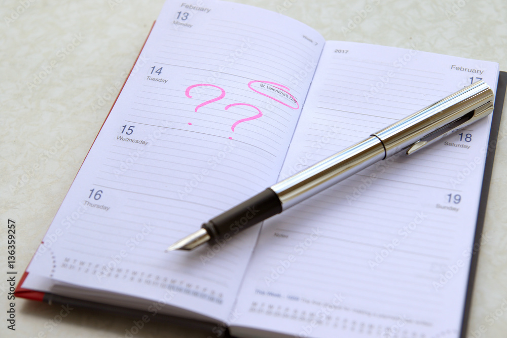 notepad with fountain pen. Man plans 14 February notepad with fountain pen. Man plans 14 February