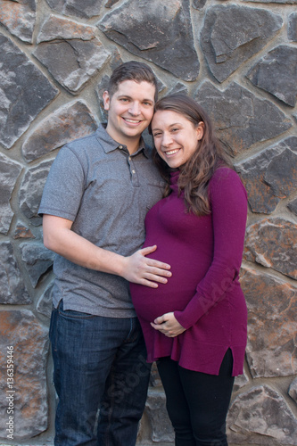 Portrait of man and pregnant women  Man and pregnant women standing outside for a maternity portrait © jhlemmer