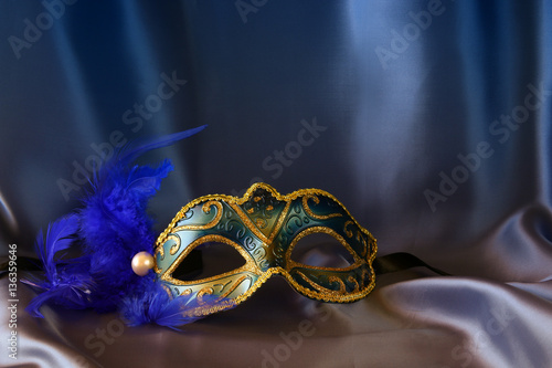 elegant venetian mask on blue silk background