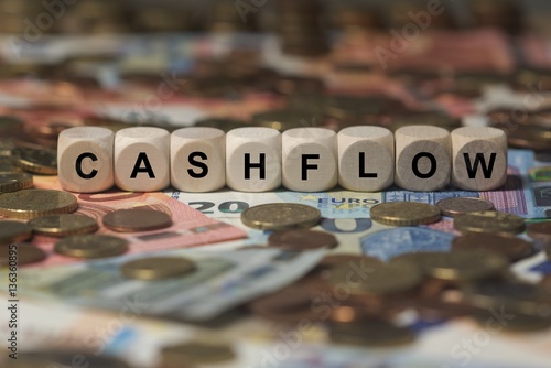 cashflow - cube with letters, money sector terms - sign with wooden cubes photo