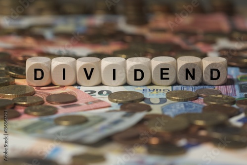 dividend - cube with letters, money sector terms - sign with wooden cubes photo