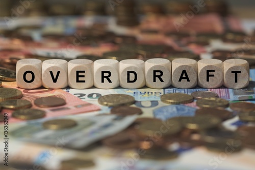 overdraft - cube with letters, money sector terms - sign with wooden cubes