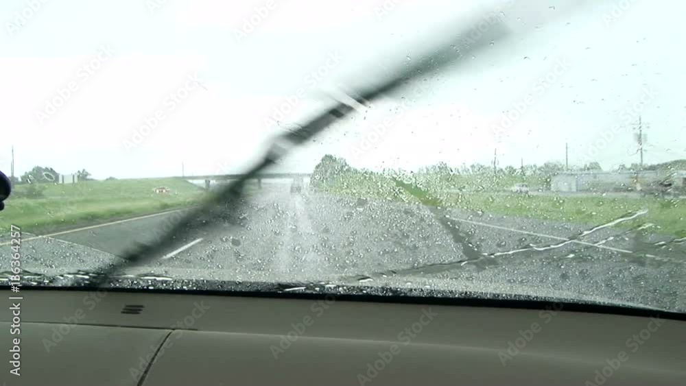 Raindrops on a windshield windshield wipers going Stock Video Adobe Stock