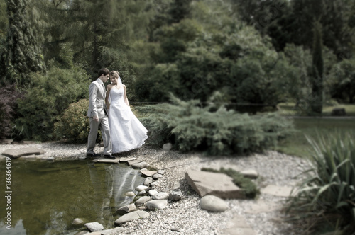 Bride and groom walking in the park