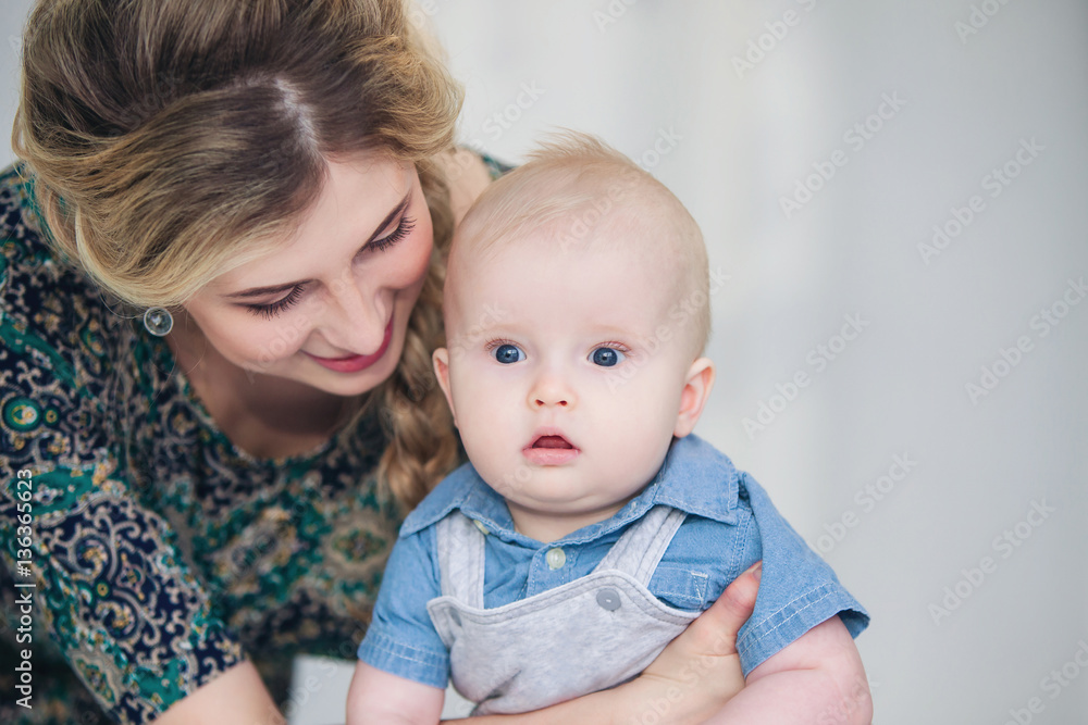 Happy loving family. Young mother holds baby son in her arms. Happy loving family. Young mother holds baby son in her arms.