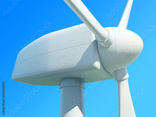 Close up of wind turbine against blue sky.