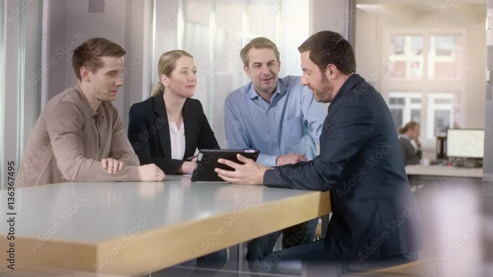 Businessman explains statistics on a tablet
Businessman explains statistics on a tablet
