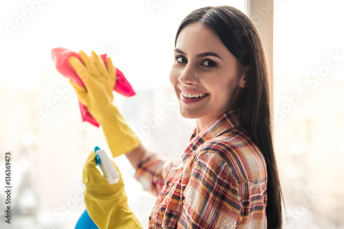 Beautiful woman cleaning house