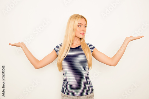 Attractive young girl choosing between two products