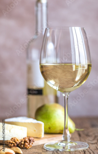 Glass of white wine with cheese and nuts