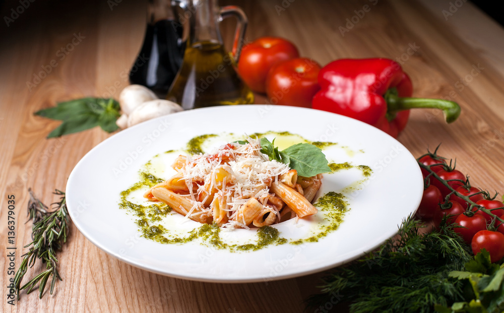 white plate with Spaghetti sprinkling parmesan cheese on a wooden table, surrounded by decor white plate with Spaghetti sprinkling parmesan cheese on a wooden table, surrounded by decor