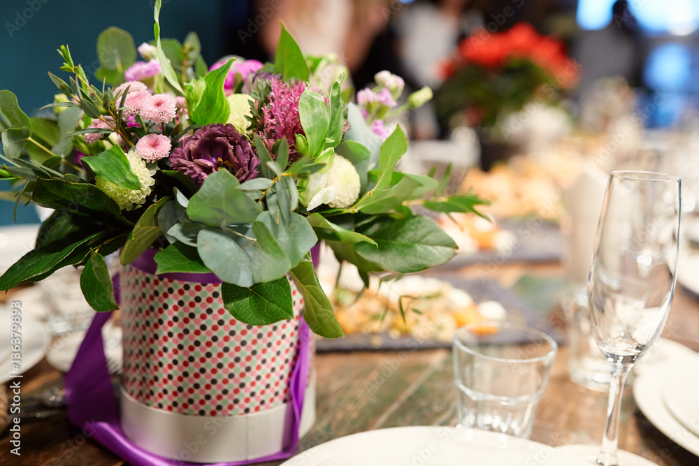 a bouquet of flowers at the banquet table in a restaurant a bouquet of flowers at the banquet table in a restaurant