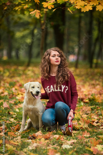 Beautiful smiling woman with cute golden retriever dog
