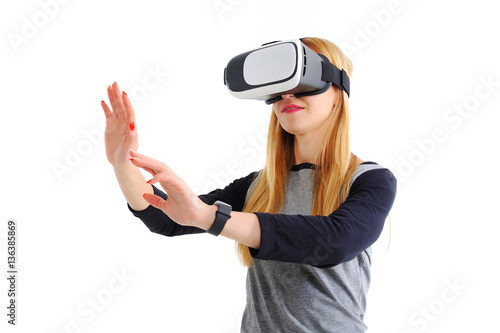 Young girl with glasses of virtual reality on a white background