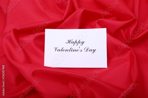 Valentines day gift box on red background. Holidays card with copy space.