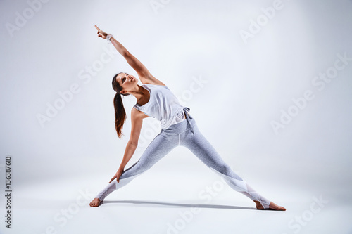 Fototapeta Naklejka Na Ścianę i Meble -  Woman doing yoga isolated on white background