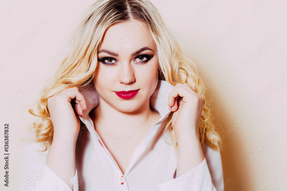 The girl with long blonde hair and bright makeup closeup